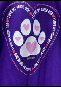 3) “I love my guide dog” is the first T-shirt we designed without a white cane. This print looks beautiful on a purple or black T-shirt (you pick!). T-shirts are 100% heavy weight cotton, so don’t size up! They won’t shrink very much. The print is made from a big, hand-drawn heart with two thin pink and white lines. Inside the lines of the heart are the words “I love my guide dog” repeated over and over in the same heart shape. In the center of the print, there is a Labrador Retriever paw print in white ink, and inside each portion of the paw is a little pink heart. Pick your size--small to 5XL.